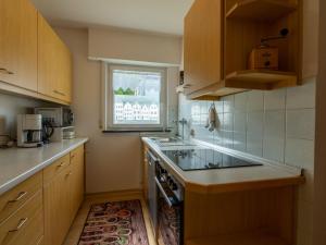 a small kitchen with a stove and a window at Holiday Home Uhu by Interhome in Dittishausen