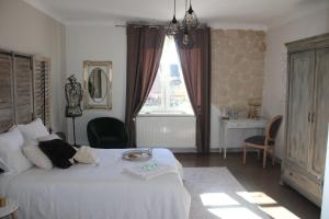Postel nebo postele na pokoji v ubytování Chambre d'hôtes Les Magnolias