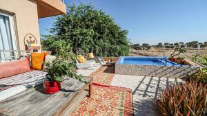a patio with a bench and a swimming pool at Einot Bar in Giv'ot Bar