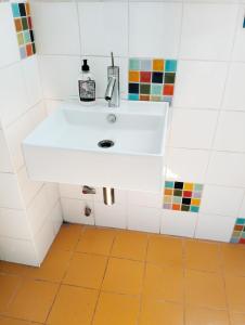 a white sink in a bathroom with tiles at Quiet light room! in Zizur Mayor