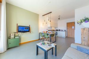 a living room with a couch and a table at Residence degli Oleandri 2A in Argegno