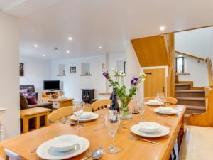 a dining room and living room with a table and chairs at Holiday Home Carnevas by Interhome in Saint Merryn