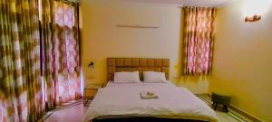 a bedroom with a large bed in a room at Hide-In Hostel Delhi in New Delhi