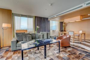 a living room with a couch and a table at InterContinental Genève by IHG in Geneva