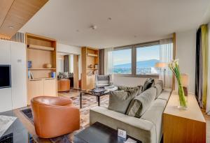 a living room with a couch and a table at InterContinental Genève by IHG in Geneva