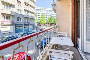 a balcony with a table and chairs on a building at Le Janet3 YourHostHelper in Grenoble