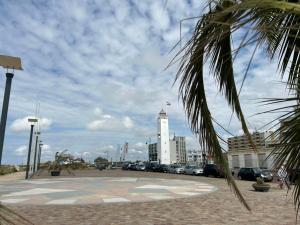 a building with a clock tower in a parking lot at Holiday Home Stern Comfort-2 by Interhome in Noordwijk