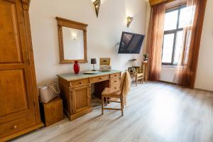a home office with a wooden desk and a mirror at Friends Hostel & Apartments in Budapest