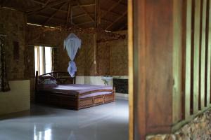 sypialnia z łóżkiem w pokoju w obiekcie Batu Kapal Lodge w mieście Bukit Lawang