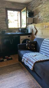 a living room with a couch and a kitchen at SebRem in Megève