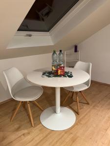 a white table with two bottles on top of it at Wohlfühl Apartment in Wendelstein