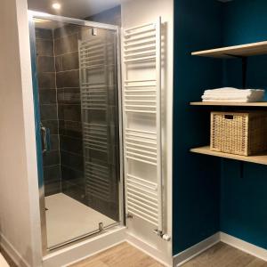 a shower with a glass door in a bathroom at L’AMANTINE Chambres d’hôtes et gîte in Bourges