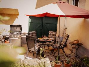 a patio with a table and chairs and an umbrella at Holiday Home Entenhaus II by Interhome in Ediger-Eller