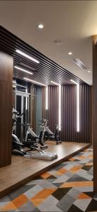 a gym with treadmills and exercise bikes in a room at Condotel S1007 Apec Mandala Mũi Né in Phan Thiet