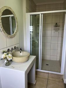 a bathroom with a sink and a shower at Accommodation @Sea Trader in St. Helena Bay +28 photos