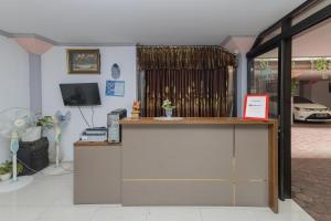 a counter in a room with a car in the window at RedDoorz At Pondok Candra in Surabaya