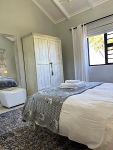 a bedroom with a large bed and a window at Accommodation @Sea Trader in St Helena Bay