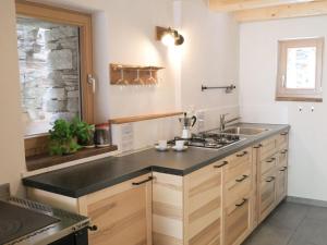 a kitchen with a sink and a stove at Holiday Home Rustico La Dimora by Interhome in Malvaglia +25 photos