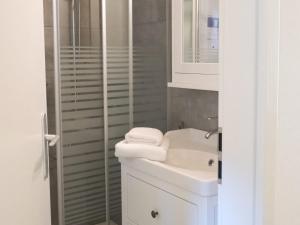 a white bathroom with a sink and a shower at Holiday Home Rustico La Dimora by Interhome in Malvaglia +27 photos