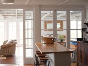 a kitchen with a table and some glass doors at Maleny Homestead & Cottage in Maleny