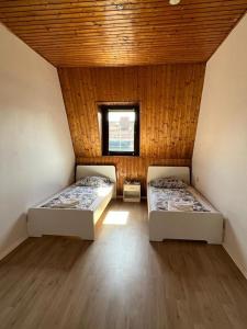 two beds in a small room with a window at DO One Bedroom Flat in Dortmund