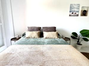 a bedroom with a large bed with two pillows at Estudio Naturista Indalo in Vera