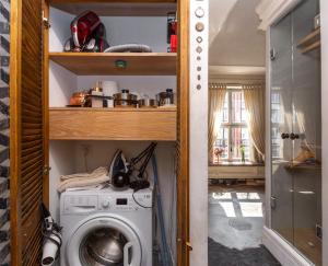 a laundry room with a washing machine in it at Downtown Apartments Old Town Paradise Lost in Gdańsk