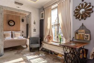 a bedroom with a bed and a table and a window at Downtown Apartments Old Town Paradise Lost in Gdańsk