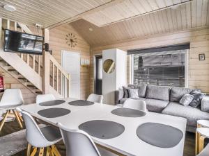 a living room with a table and a couch at Holiday Home Himoksen keiju 1 by Interhome in Jämsä
