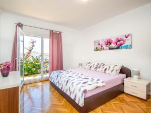 a bedroom with a bed and a large window at Holiday Home Gabi by Interhome in Brodarica