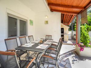 a dining table and chairs on a patio at Holiday Home Gabi by Interhome in Brodarica