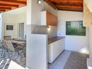 a kitchen and dining room with a table and chairs at Holiday Home Gabi by Interhome in Brodarica +16 photos