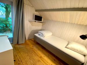 A bed or beds in a room at Holiday Home Iskra - 900m from the sea in NW Jutland by Interhome