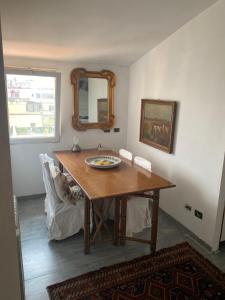 a dining room with a table and a mirror at Apartment in Roma with Terrace in Rome
