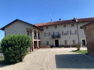 a large white building with a red roof at Apartment Oleandro by Interhome in Costigliole dʼAsti
