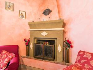 a living room with a fireplace in a pink wall at Holiday Home Antica Pietra by Interhome in La Cava