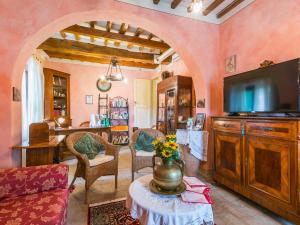 a living room with a large television and a table at Holiday Home Antica Pietra by Interhome in La Cava
