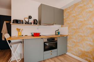 a kitchen with a counter and a stove top oven at RÉPUBLIC’STUDIO AVEC PARKING ! in Nantes