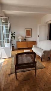 a bedroom with a bed and a bench and a table at Casa do Poço in Setúbal