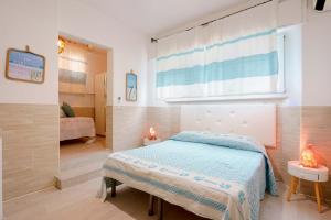 een kleine slaapkamer met een bed en een raam bij Villabeachcity Guesthouse in Cagliari