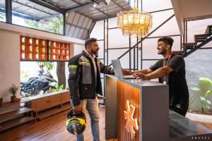 two men standing at a counter with a ball at Zostel Kochi (Ernakulam) in Ernakulam