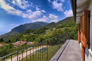 a balcony with a view of mountains at Villa Pineta - Theater Home in Tignale