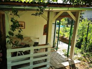 a porch of a house with a fence at Perníková chalúpka in Bojnice +9 photos
