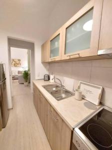 a kitchen with a sink and a counter top at Keramikos at Plateon central Athens apartment by SuperHost Hub in Athens