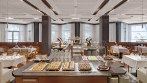 a dining room with a table with food on it at Precise Resort El Rompido-The Hotel in El Rompido +37 photos