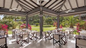 a dining room with tables and chairs in a pavilion at Precise Resort El Rompido-The Hotel in El Rompido