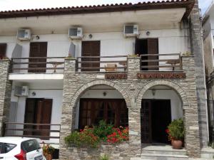 a building with a sign on the front of it at Hotel Hellinikon in Ouranoupoli +30 photos