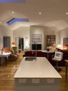 a living room with a kitchen and a living room with a couch at 2 Quay Road, Killala. Stunning Sea Front Cottage in Killala