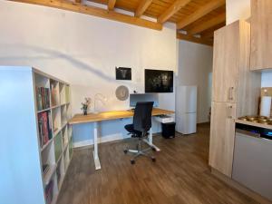 an office with a desk and a chair in a room at Cozy private rooms & apartments in Kahl am Main