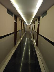 an empty hallway in an office building with a long aisle at Sambhrama Residency in Shimoga